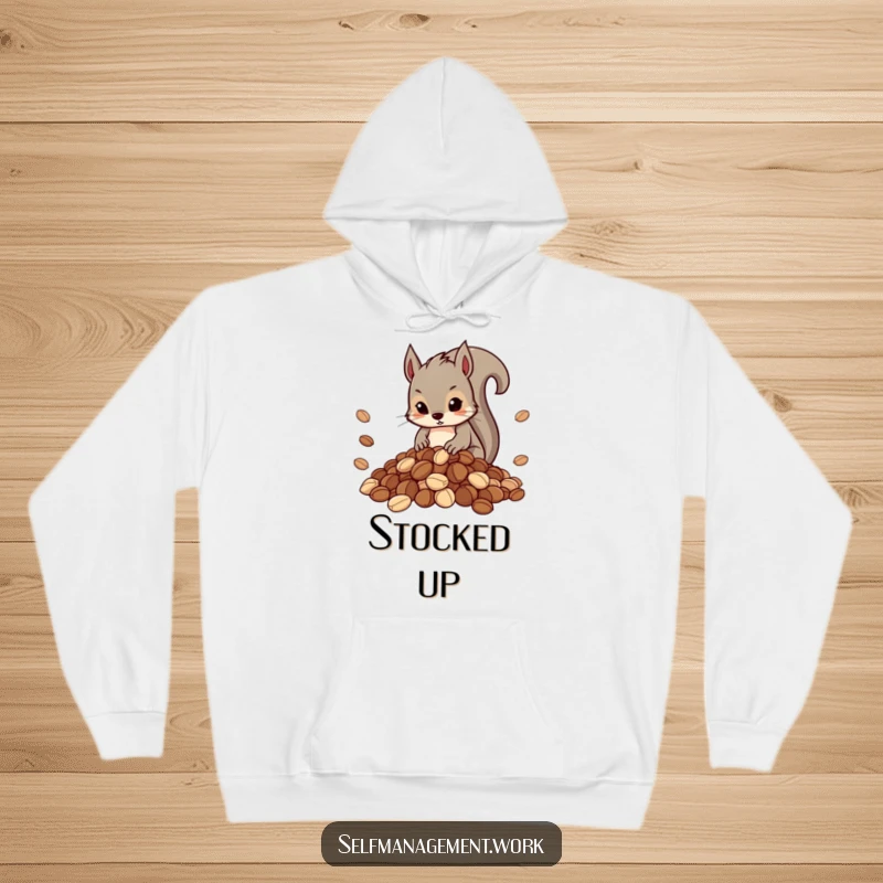 Funny hoodie depicting a determined squirrel character carefully arranging a large, neat pile of nuts, related to hoarding.