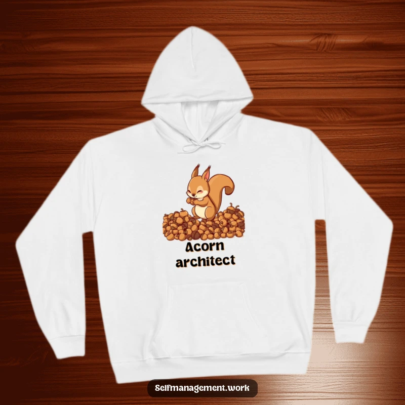 Energetic squirrel character meticulously organizing acorns into neat piles, soft hoodie material, humorous apparel.